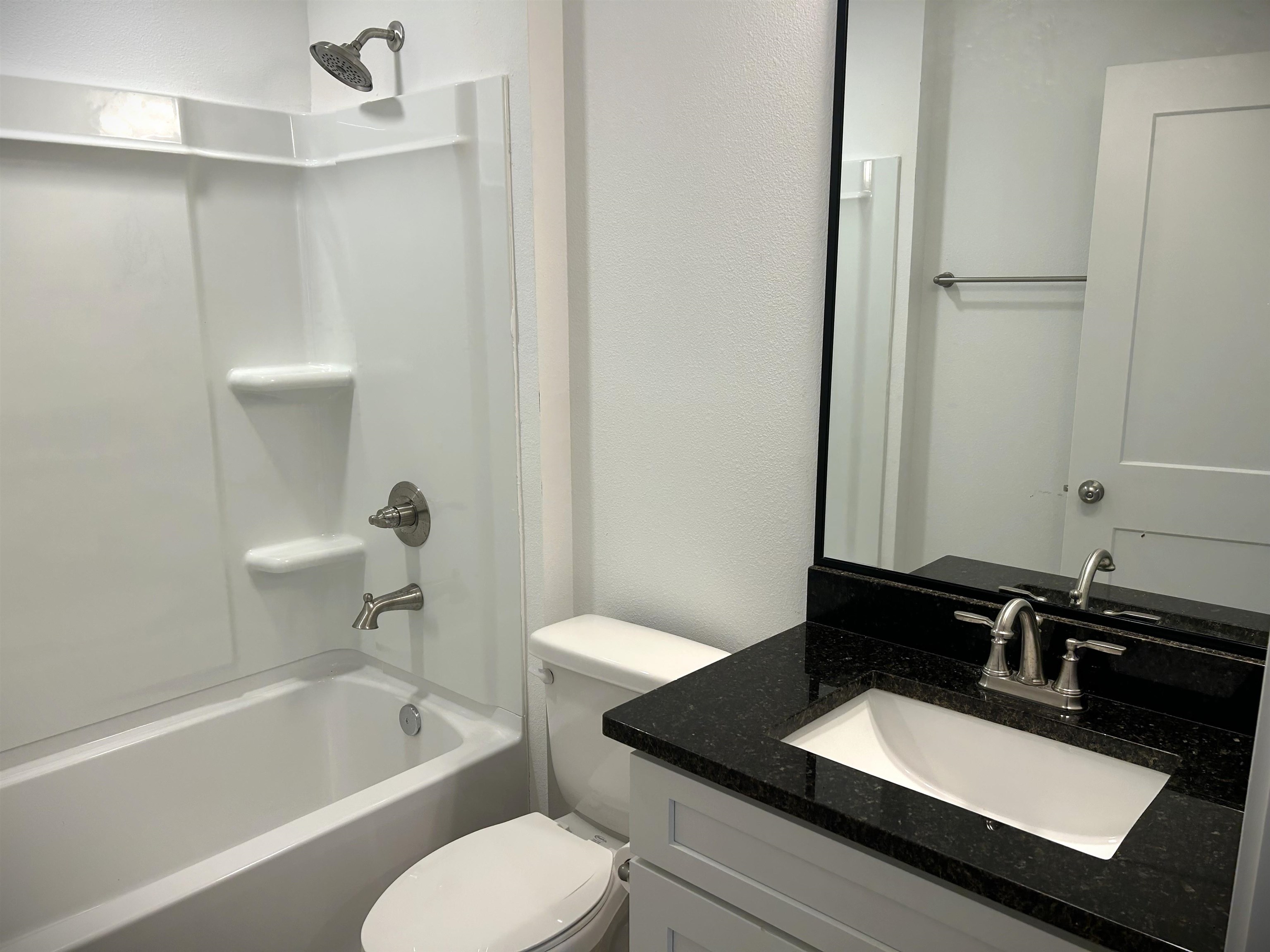 3347 7th Street Elkton, FL 32033 - Photo 11 of 17 a bathroom with a granite countertop sink and a bathtub