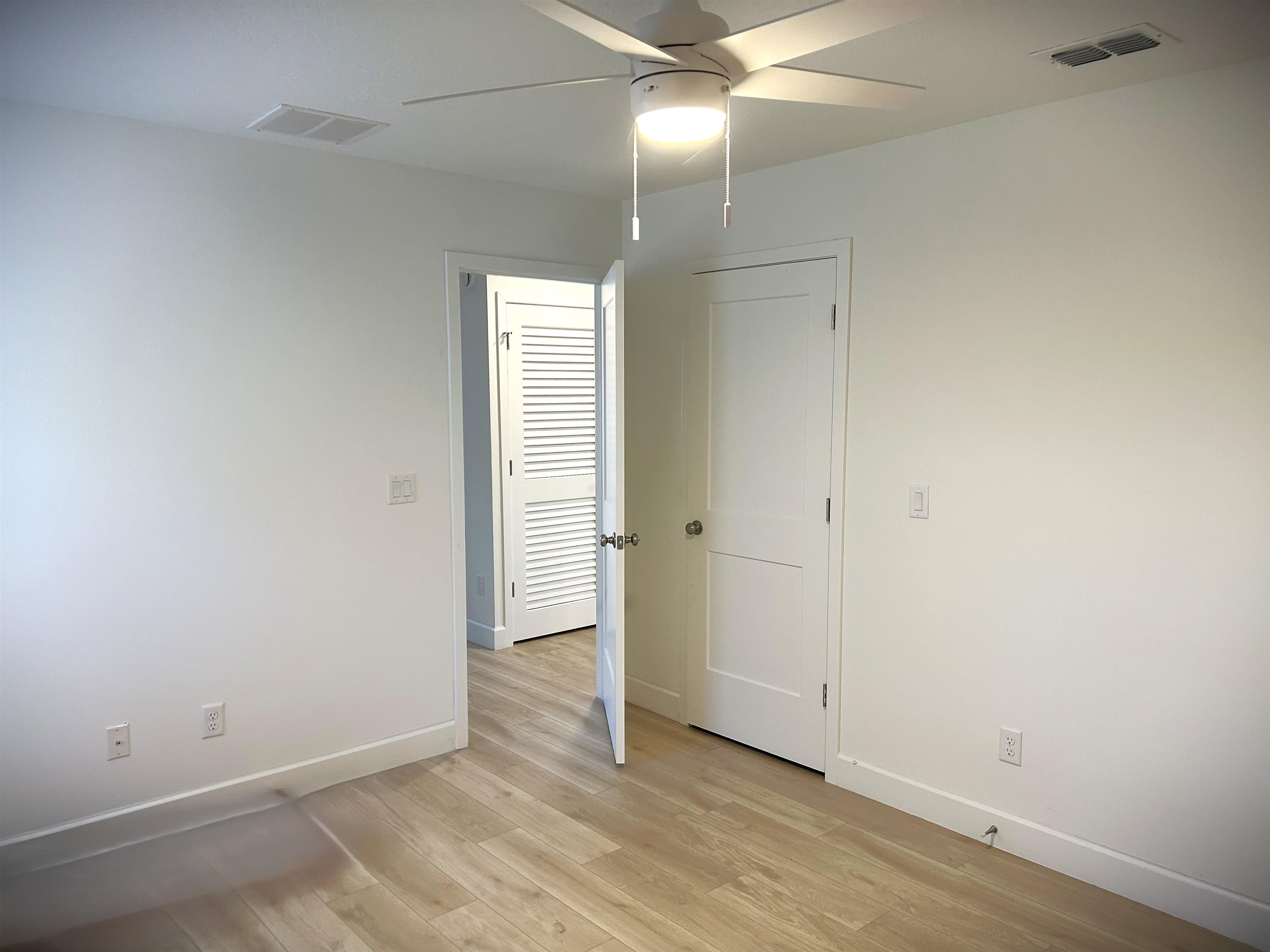 3347 7th Street Elkton, FL 32033 - Photo 12 of 17 an empty room with wooden floor