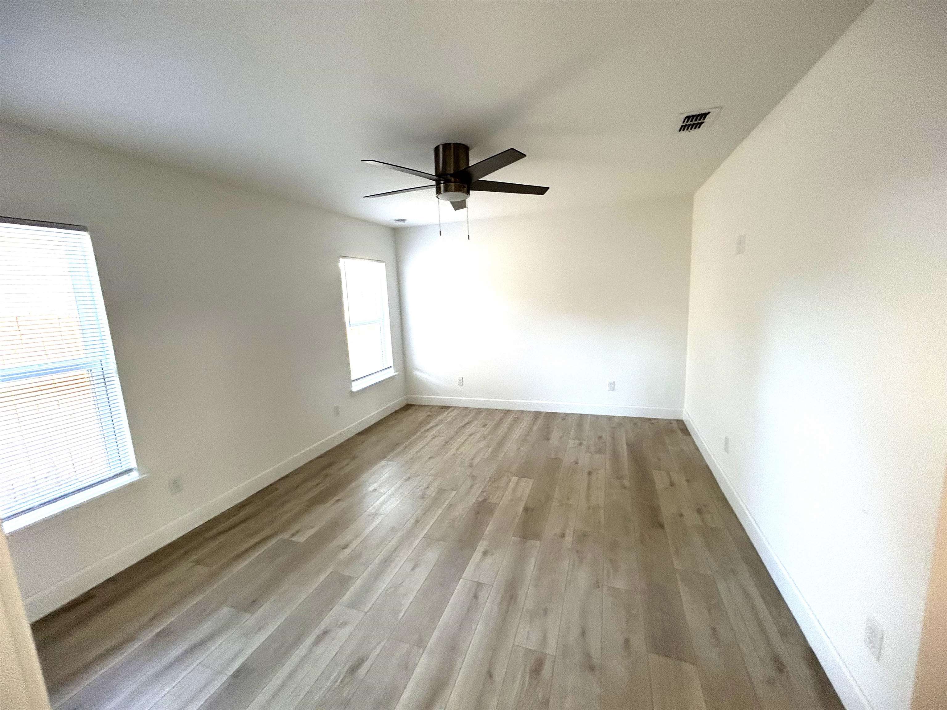 3347 7th Street Elkton, FL 32033 - Photo 15 of 17 wooden floor in an empty room with a window