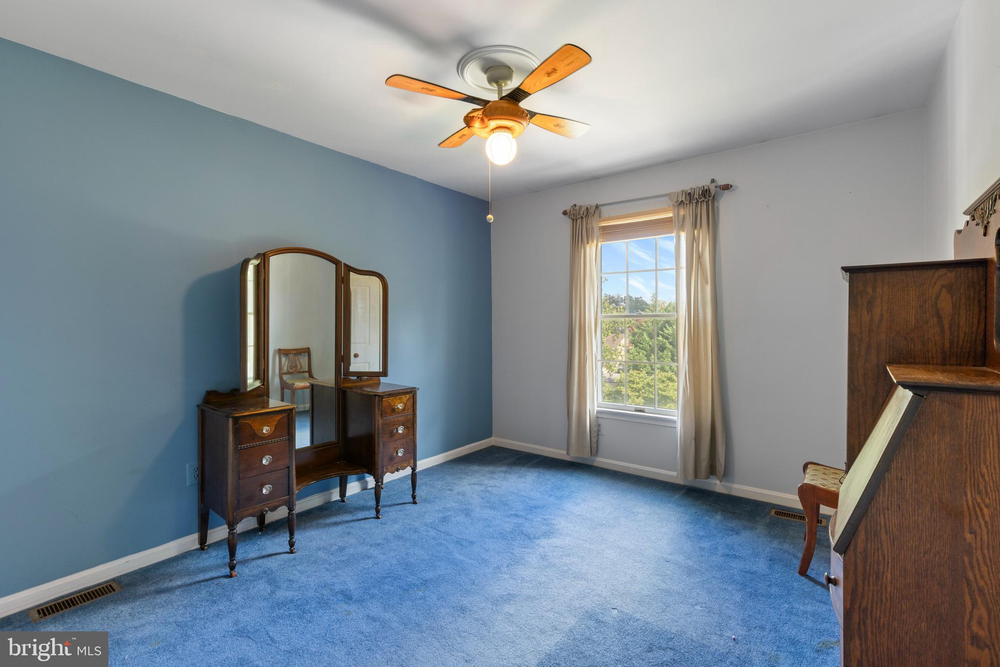 9209 Ramblebrook Road Baltimore, MD 21236 - Photo 33 of 54 an empty room with windows and ceiling fan