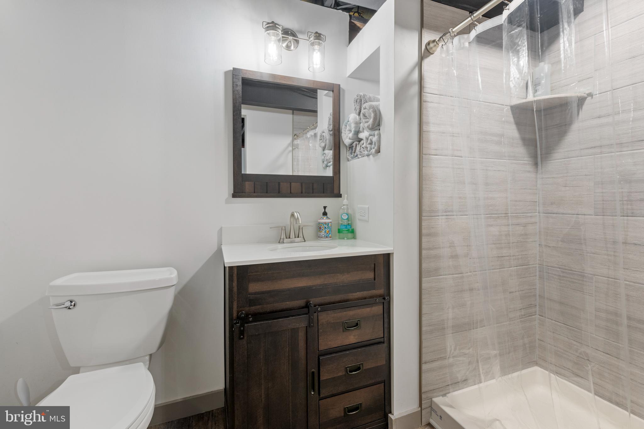 9209 Ramblebrook Road Baltimore, MD 21236 - Photo 42 of 54 a bathroom with a sink toilet and shower