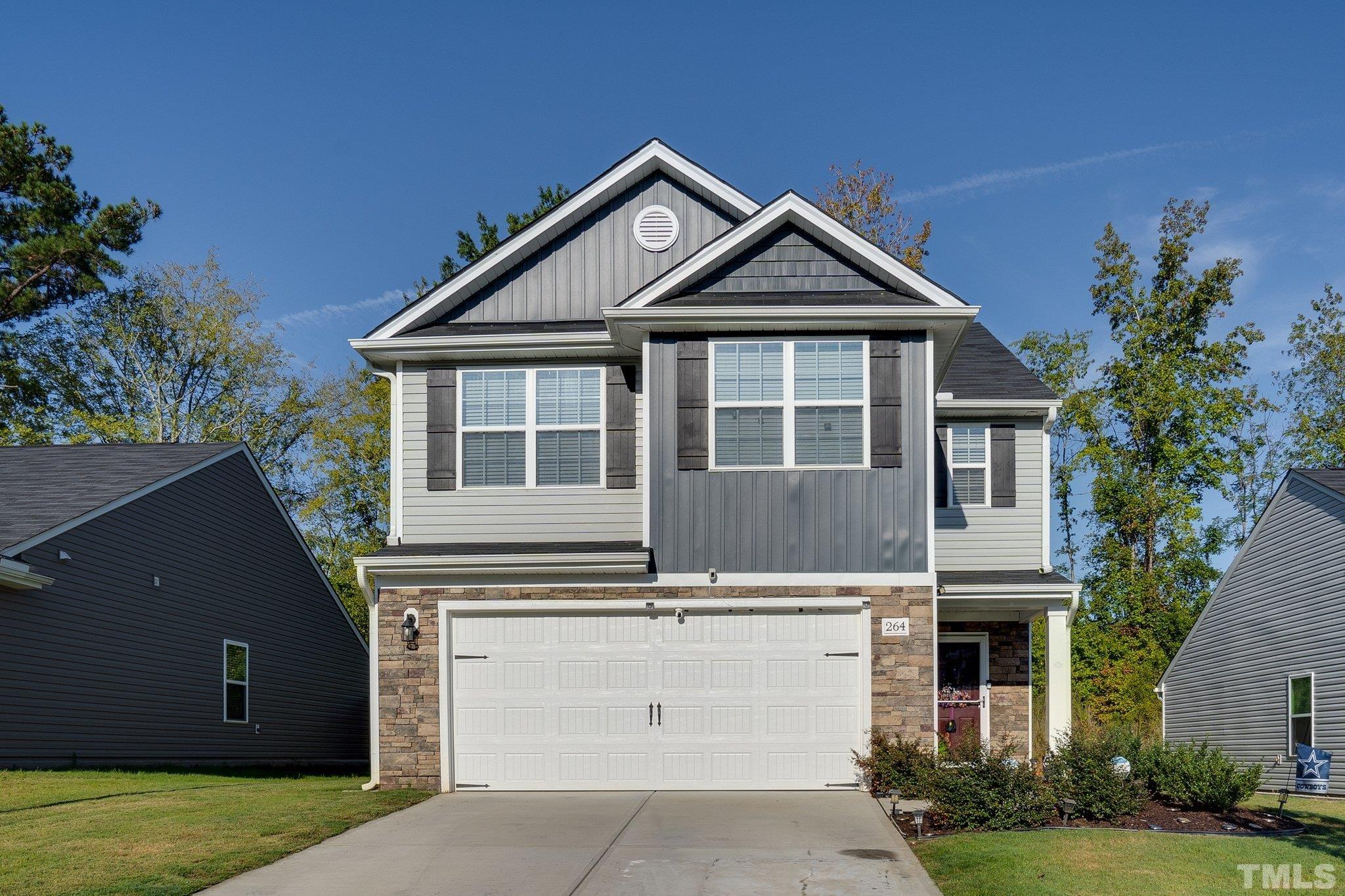 264 Rustling Way Zebulon, NC 27597 - Photo 2 of 22 a front view of a house with garden