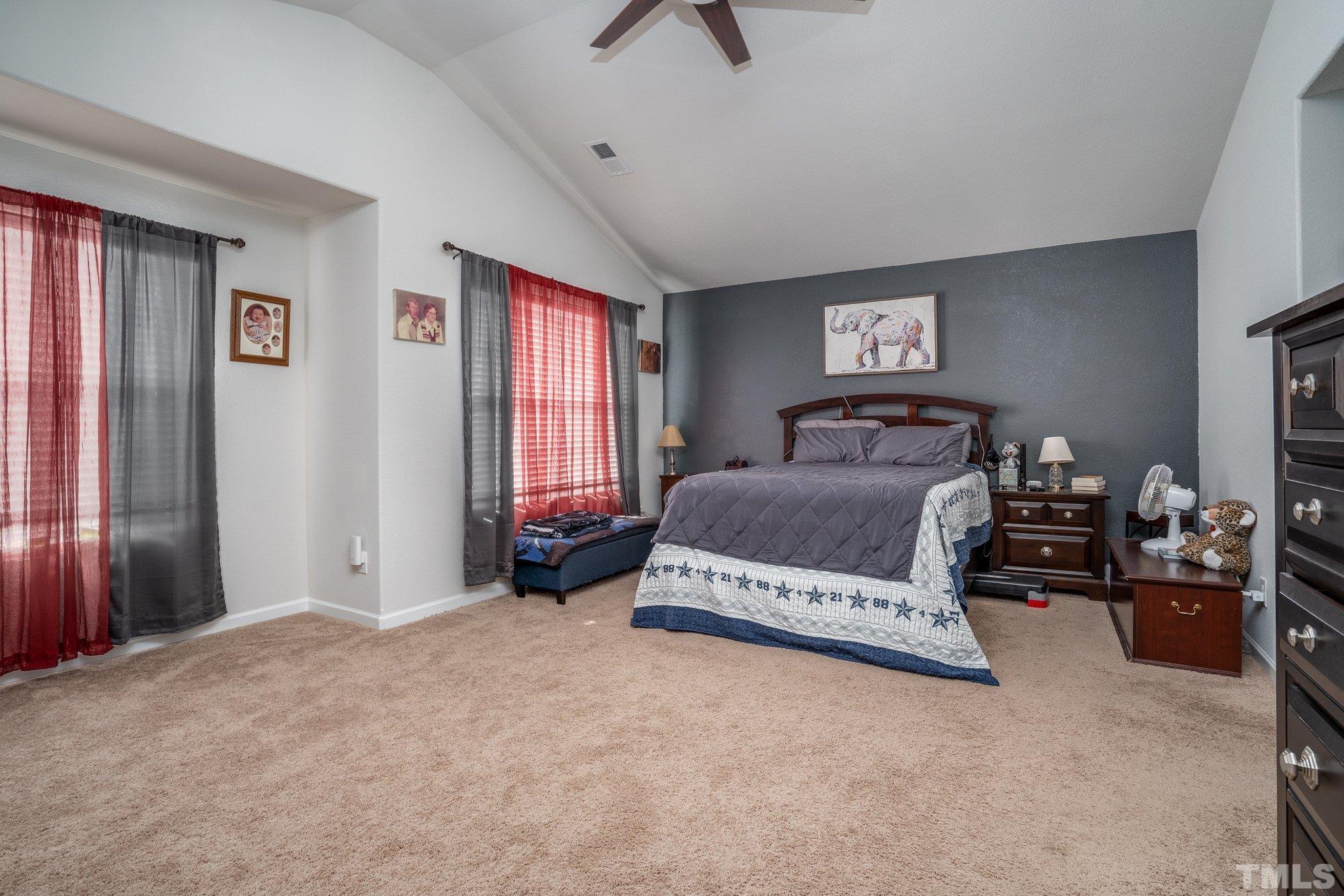 264 Rustling Way Zebulon, NC 27597 - Photo 22 of 22 a bedroom with a bed and a chandelier