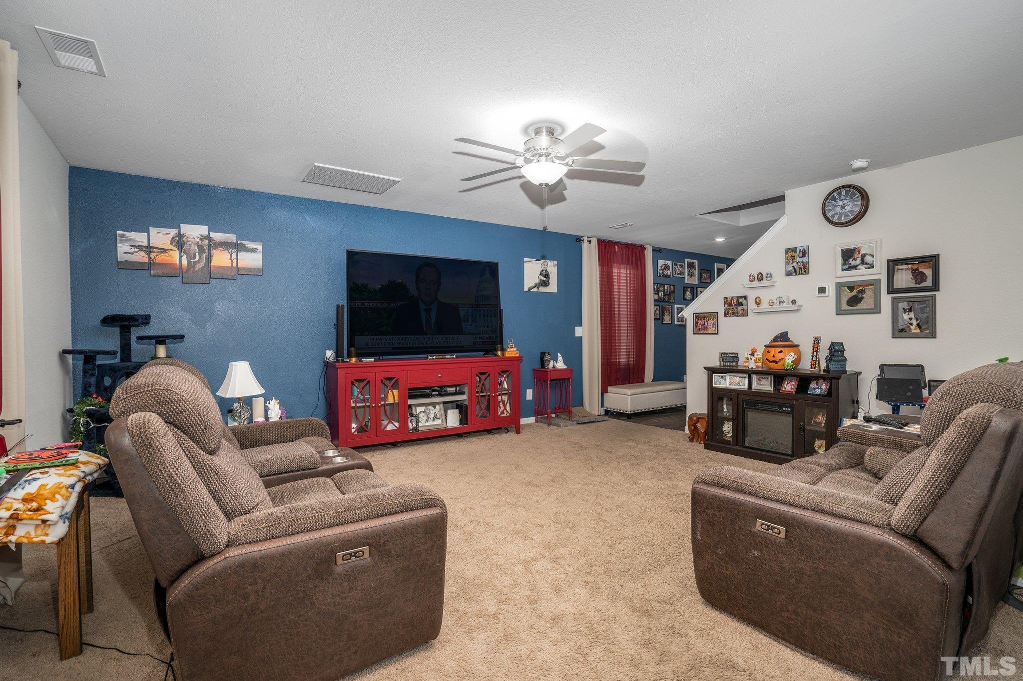 264 Rustling Way Zebulon, NC 27597 - Photo 7 of 22 a living room with furniture and a flat screen tv