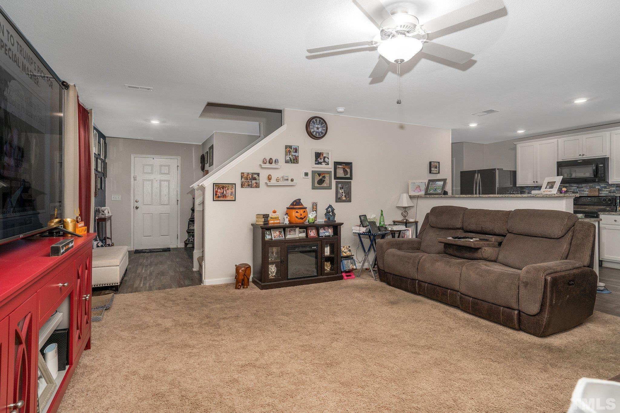264 Rustling Way Zebulon, NC 27597 - Photo 8 of 22 a living room with furniture and a flat screen tv