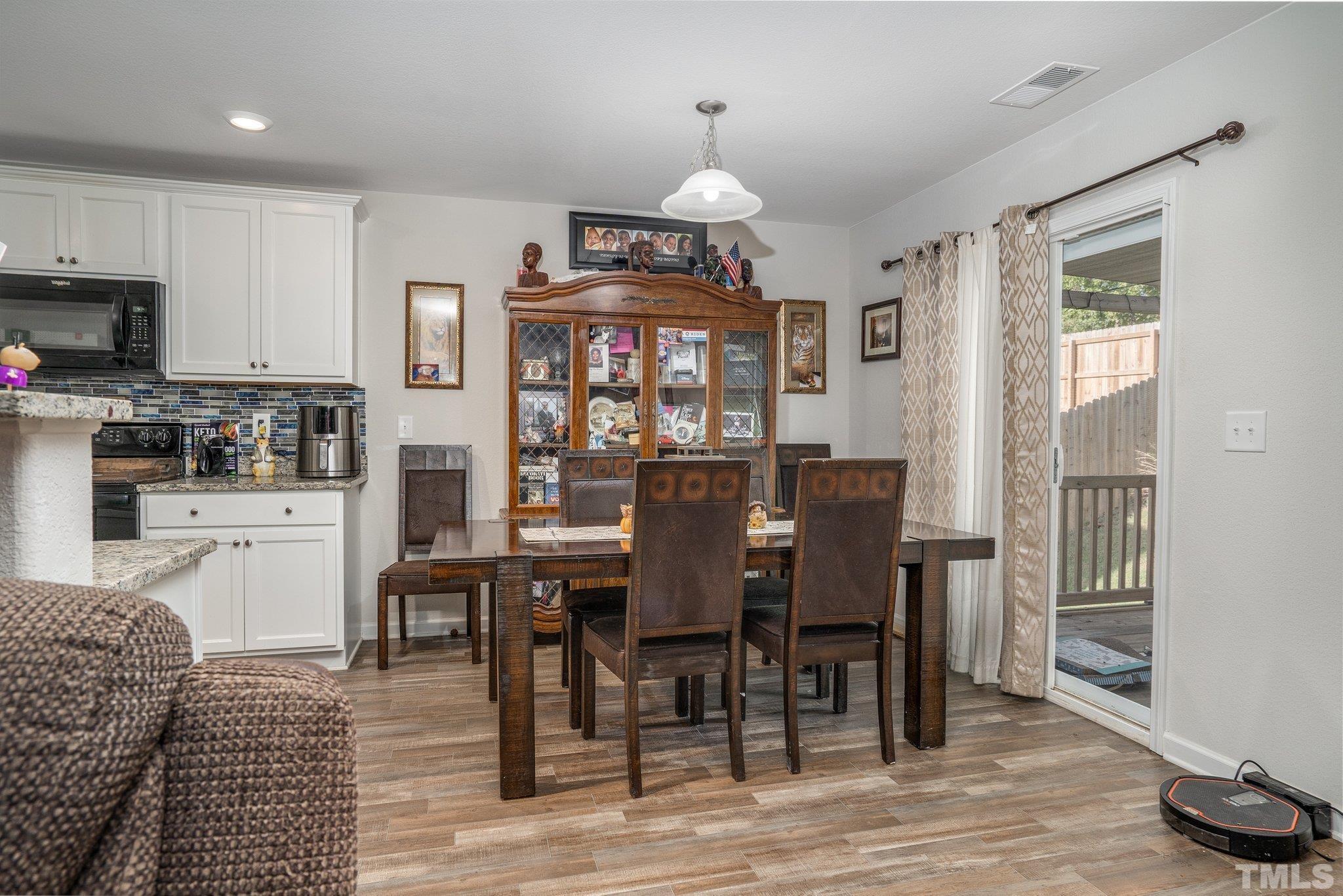 264 Rustling Way Zebulon, NC 27597 - Photo 9 of 22 a view of a dining room with furniture window and wooden floor