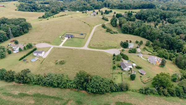 an aerial view of a house with a yard