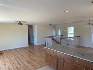 a view of a kitchen with a sink wooden floor and a window