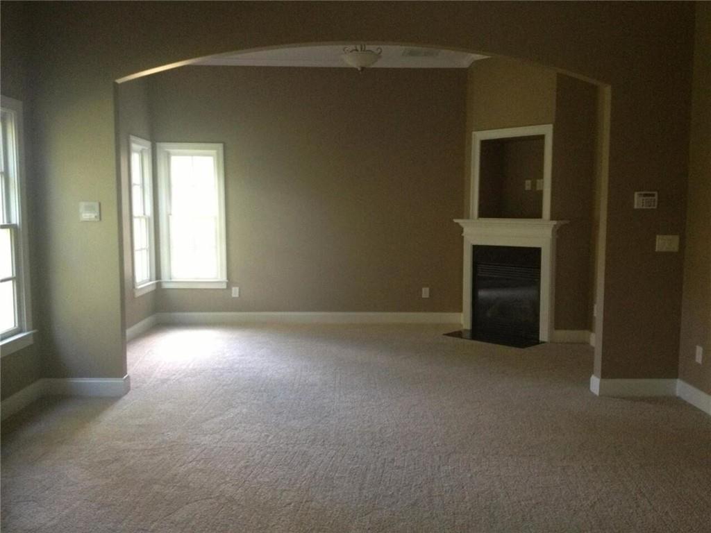 1059 Concerto Court Fairburn, GA 30213 - Photo 5 of 14 an empty room with windows and fireplace