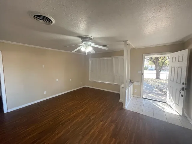 wooden floor in an empty room with a window
