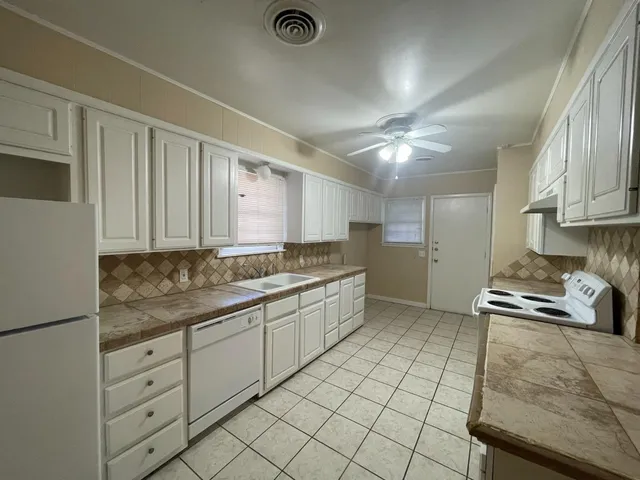 a kitchen with a sink cabinets and window