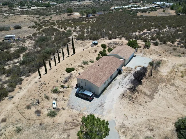 a view of a yard with snow on the road