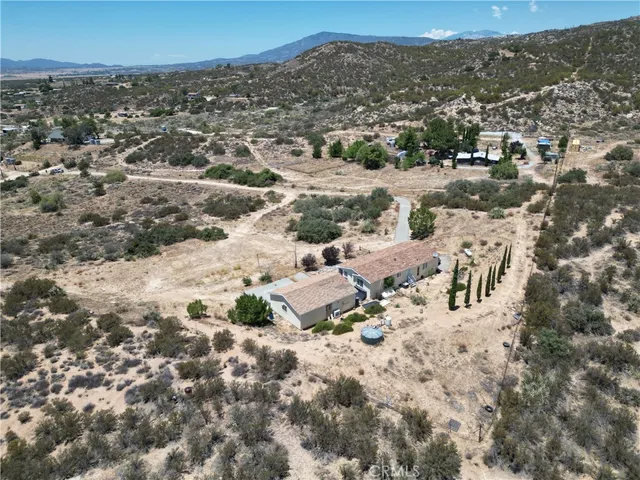 a view of a dry yard with wooden fence