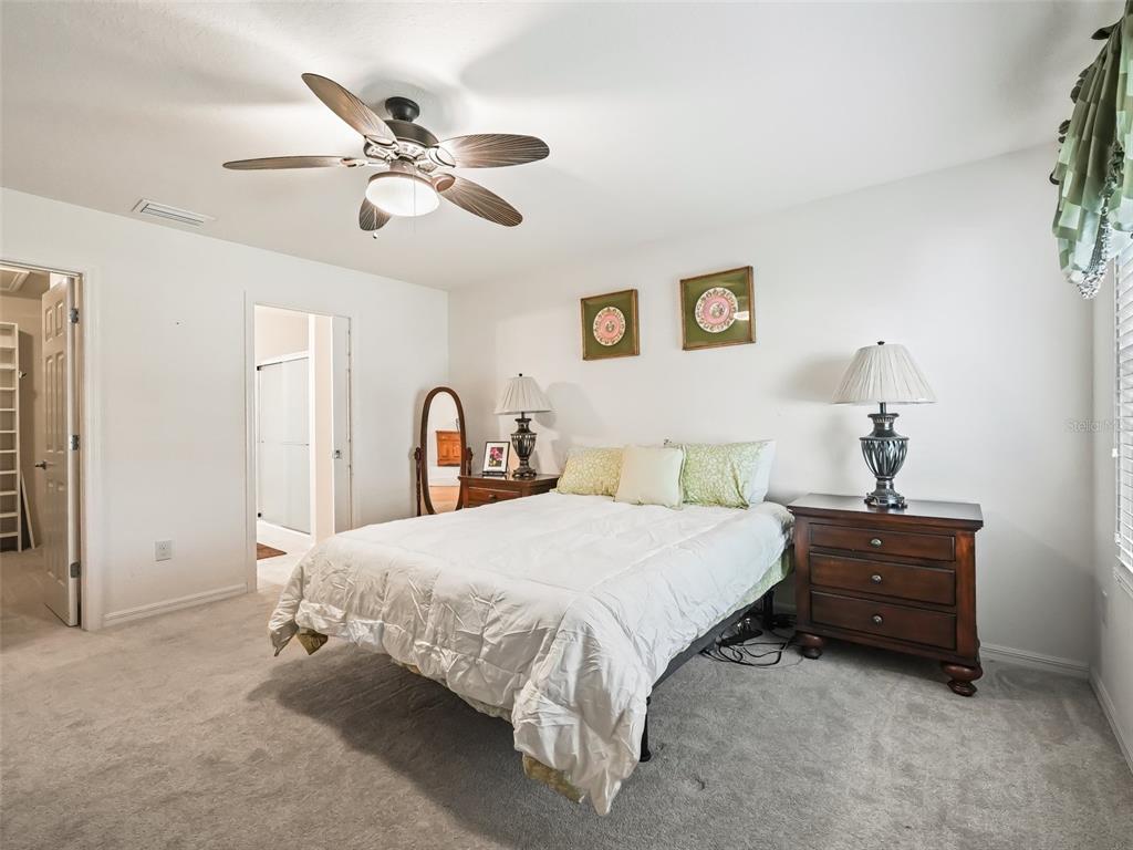 2360 Hopespring Loop The Villages, FL 32162 - Photo 14 of 30 a bedroom with a bed and a ceiling fan