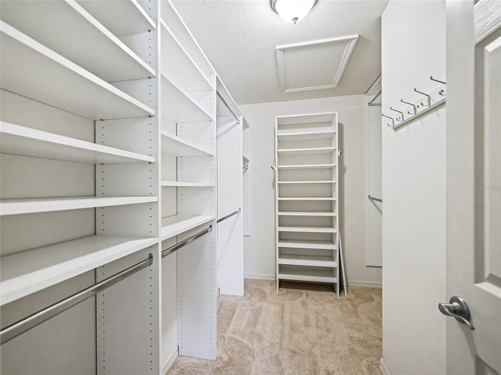 2360 Hopespring Loop The Villages, FL 32162 - Photo 18 of 30 a view of walk in closet with empty racks