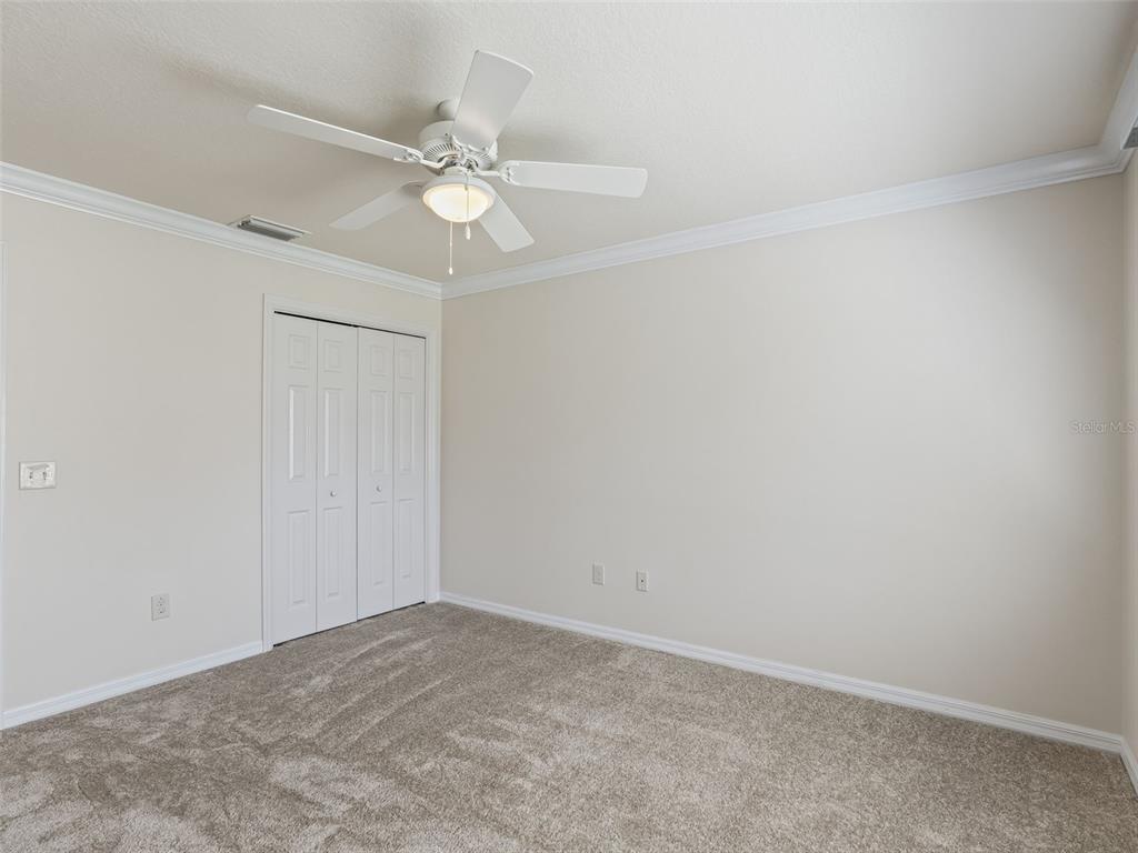 2360 Hopespring Loop The Villages, FL 32162 - Photo 19 of 30 an empty room with a fan and a fan