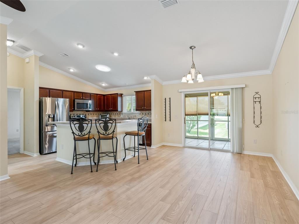 2360 Hopespring Loop The Villages, FL 32162 - Photo 9 of 30 a view of a kitchen with dining room wooden floor and windows