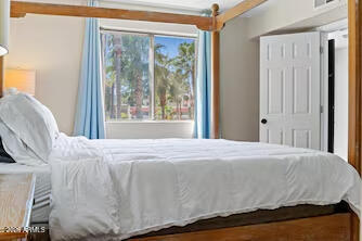 7625 East Camelback Road, Unit B228 Scottsdale, AZ 85251 - Photo 15 of 24 a large bed sitting in a bedroom next to a window