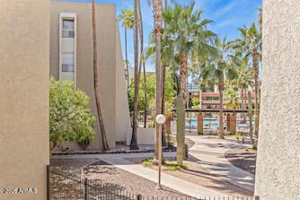 7625 East Camelback Road, Unit B228 Scottsdale, AZ 85251 - Photo 23 of 24 a front view of a house with a yard