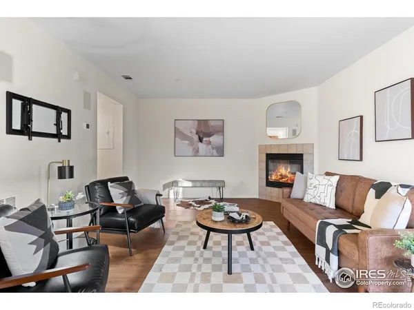 a living room with furniture a rug and a fireplace