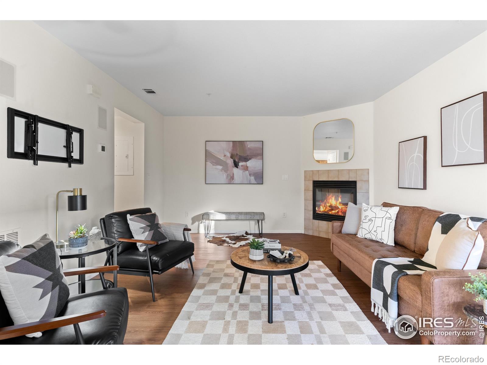 2900 Purcell Street, Unit O4 Brighton, CO 80601 - Photo 13 of 28 a living room with furniture a rug and a fireplace
