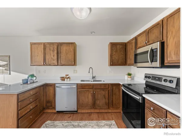 a kitchen with stainless steel appliances a sink stove and cabinets