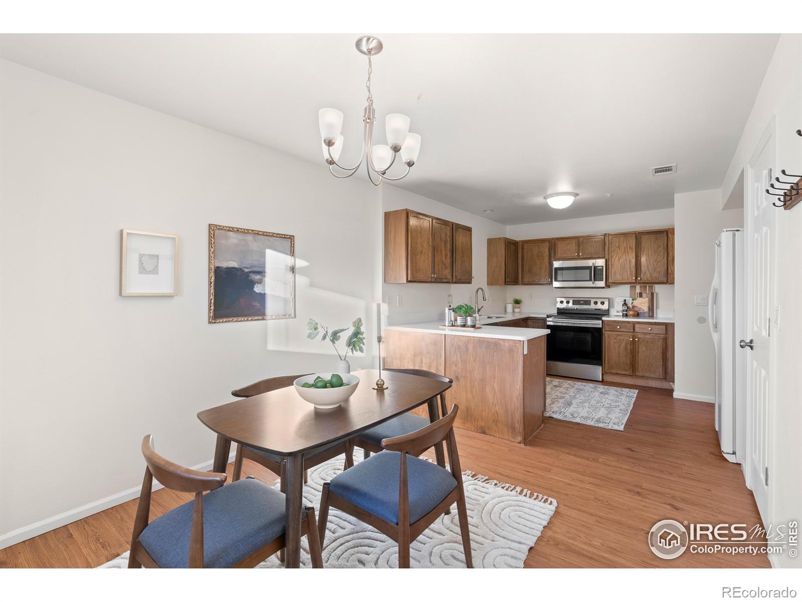 2900 Purcell Street, Unit O4 Brighton, CO 80601 - Photo 17 of 28 a view of a dining room with furniture and wooden floor