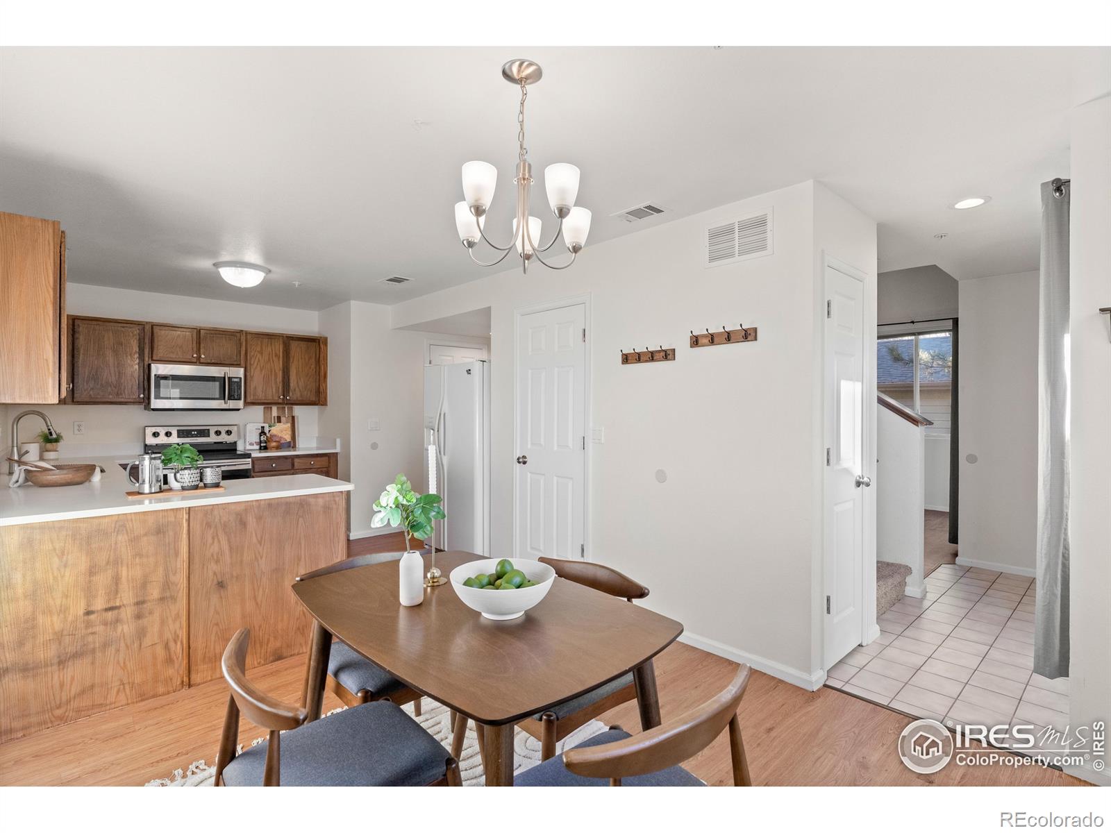 2900 Purcell Street, Unit O4 Brighton, CO 80601 - Photo 18 of 28 a view of a dining room with furniture and a chandelier