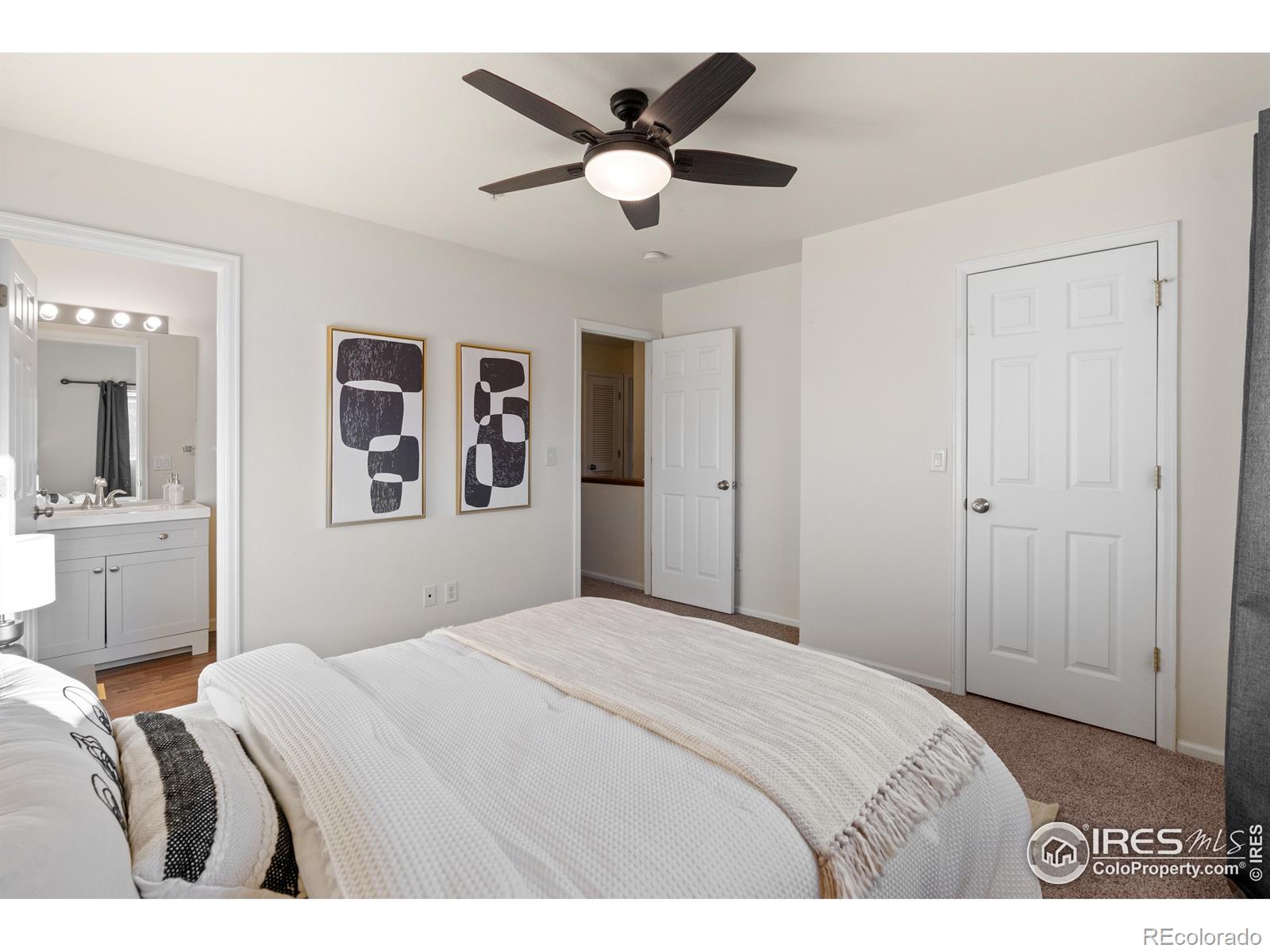 2900 Purcell Street, Unit O4 Brighton, CO 80601 - Photo 20 of 28 a bedroom with a large bed and a chandelier
