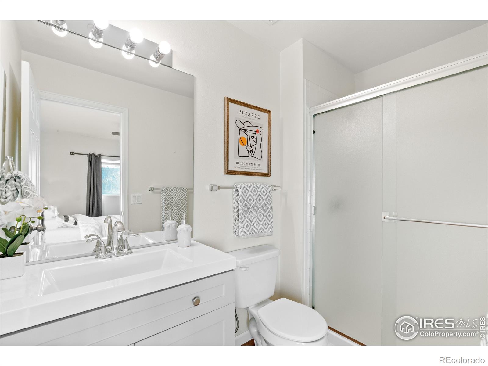 2900 Purcell Street, Unit O4 Brighton, CO 80601 - Photo 21 of 28 a bathroom with a sink mirror vanity and toilet