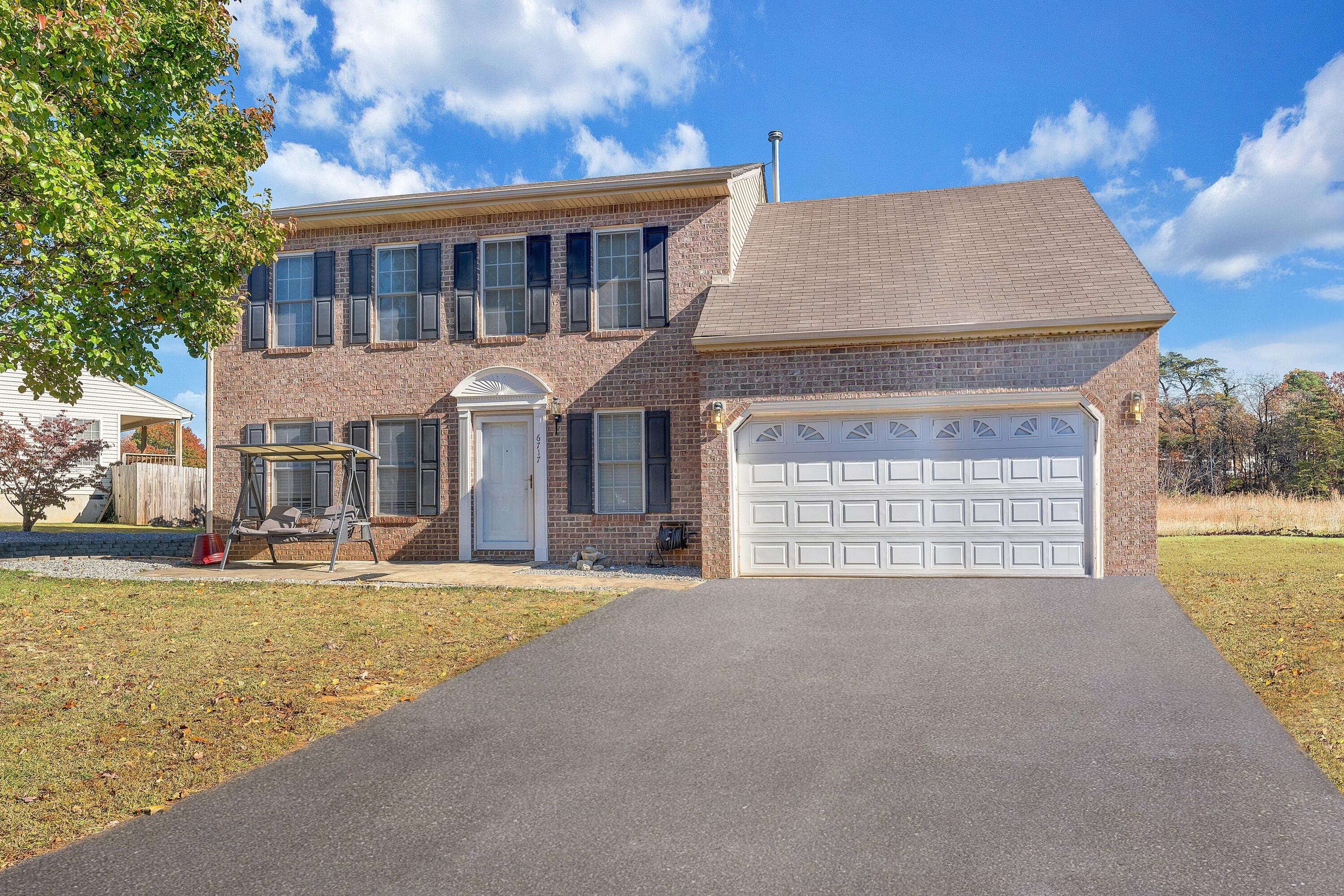 6717 Albert Road Roanoke, VA 24019 - Photo 1 of 48 a front view of a house with a yard outdoor seating and garage