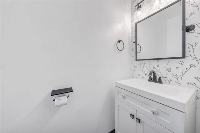 a spacious bedroom with a bed and a chandelier