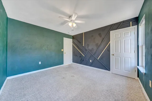 an empty room with a ceiling fan