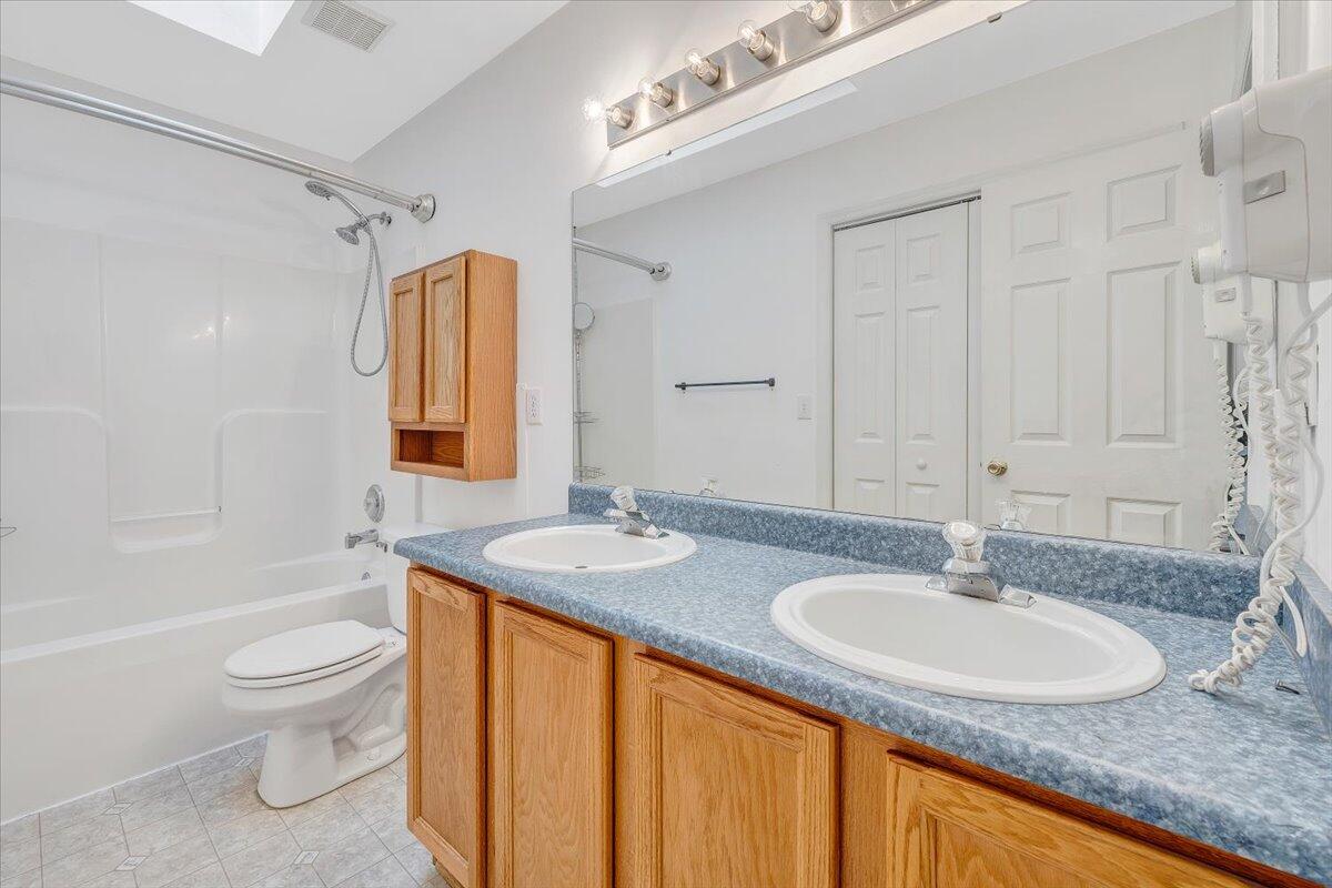 6717 Albert Road Roanoke, VA 24019 - Photo 36 of 48 a bathroom with a granite countertop sink toilet and shower