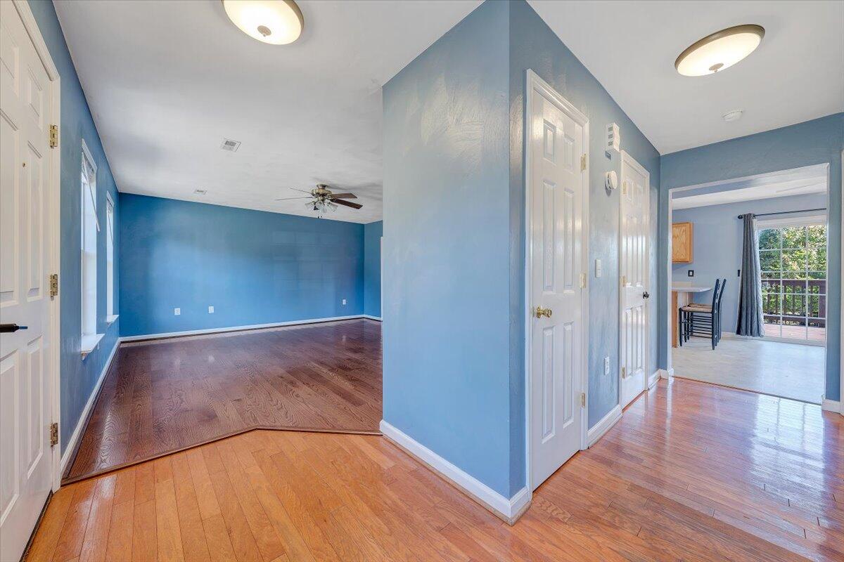 6717 Albert Road Roanoke, VA 24019 - Photo 4 of 48 a view of a hallway to an empty room with wooden floor and a window