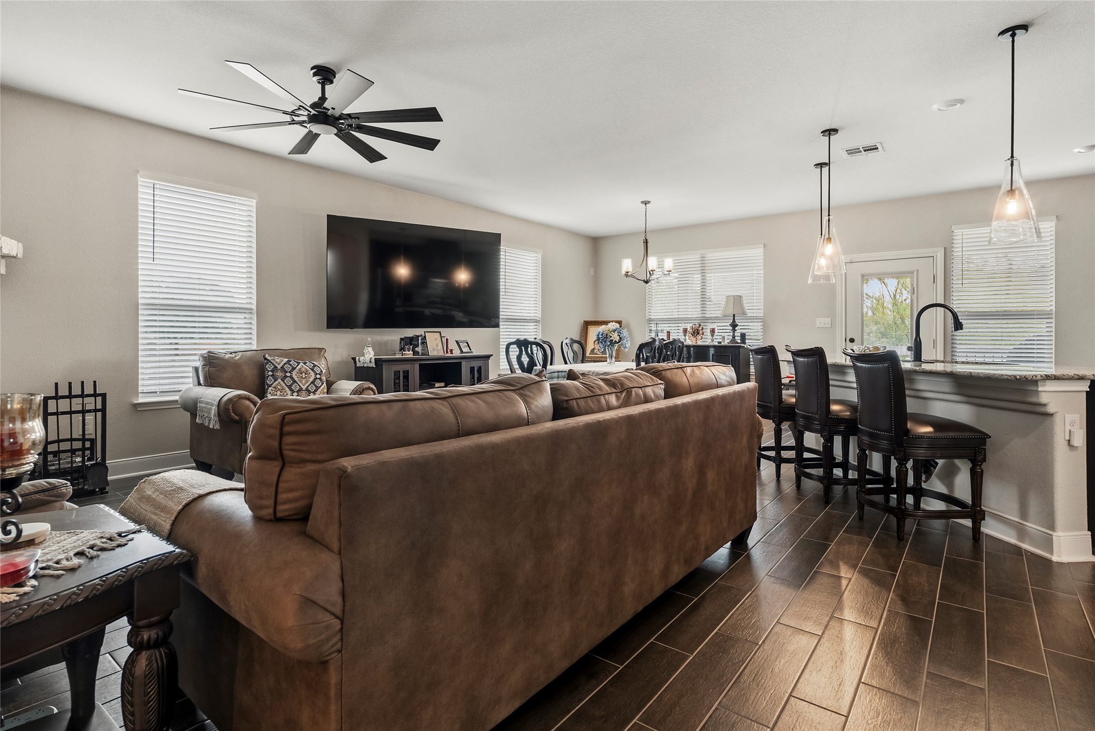 105 West Point Way Elgin, TX 78621 - Photo 26 of 27 Open-concept living space featuring wood-finish flooring, recessed lighting, and a contemporary ceiling fan