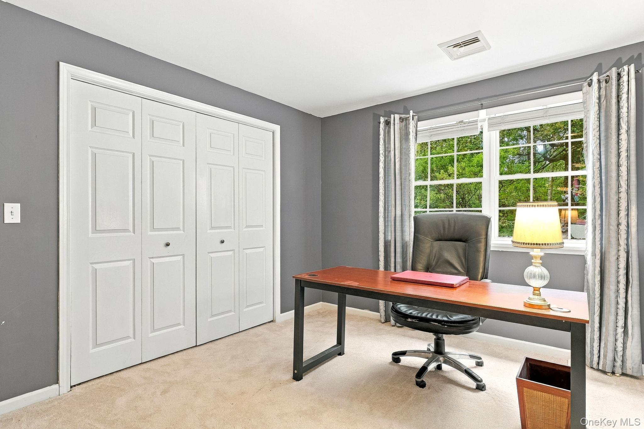 48 Mac Farlane Road Wappingers Falls, NY 12590 - Photo 29 of 47 Double-panel closet doors, two large windows, wall-to-wall carpeting, and neutral wall paint