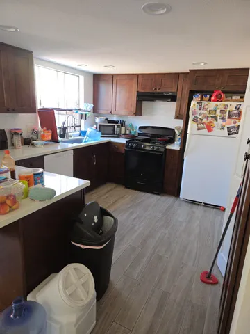 a kitchen with a sink appliances and cabinets