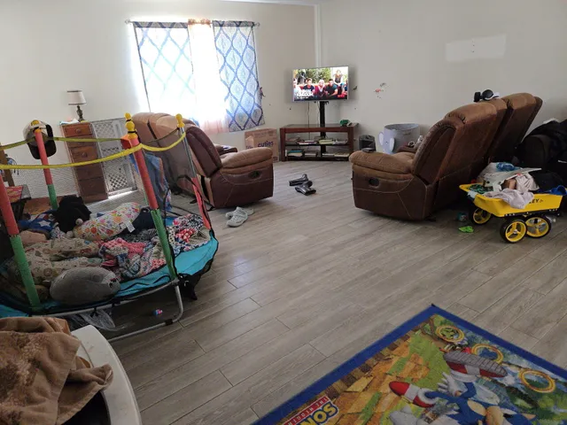 a bedroom with furniture and a wooden floor