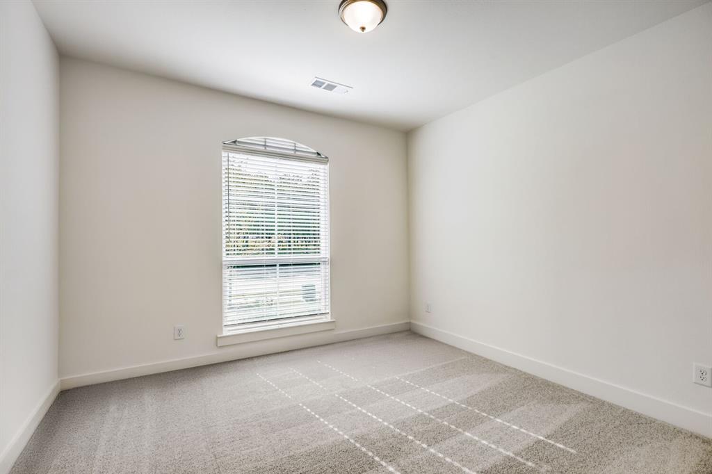 4314 Haley Way Oak Point, TX 75068 - Photo 16 of 28 Arched window with blinds, light gray wall-to-wall carpeting, white baseboards, and a flush mount ceiling light fixture