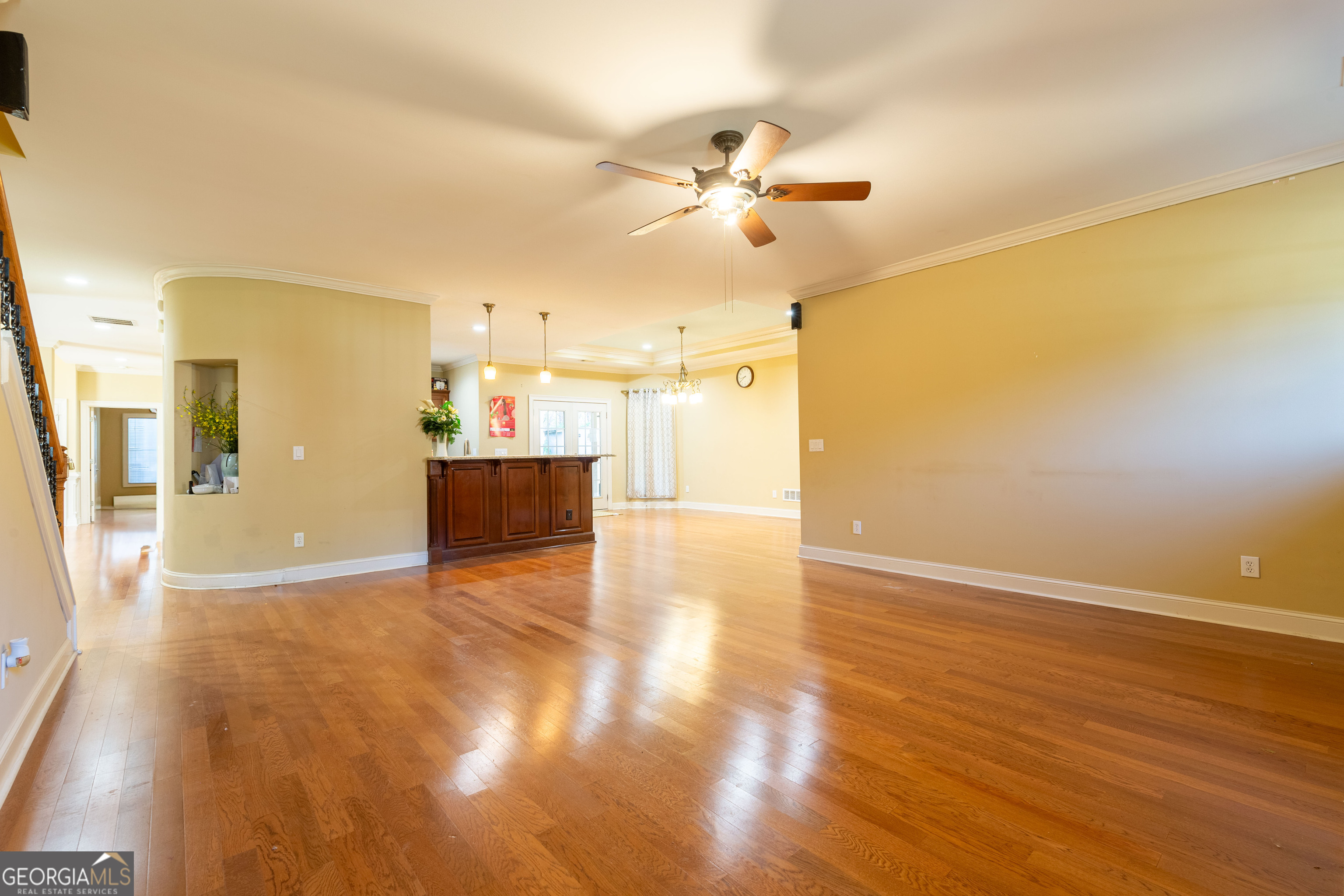 3194 Liverpool Street Jonesboro, GA 30236 - Photo 11 of 44 a view of a big room with wooden floor and a chandelier fan