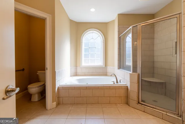 a spacious bathroom with a bathtub and a shower