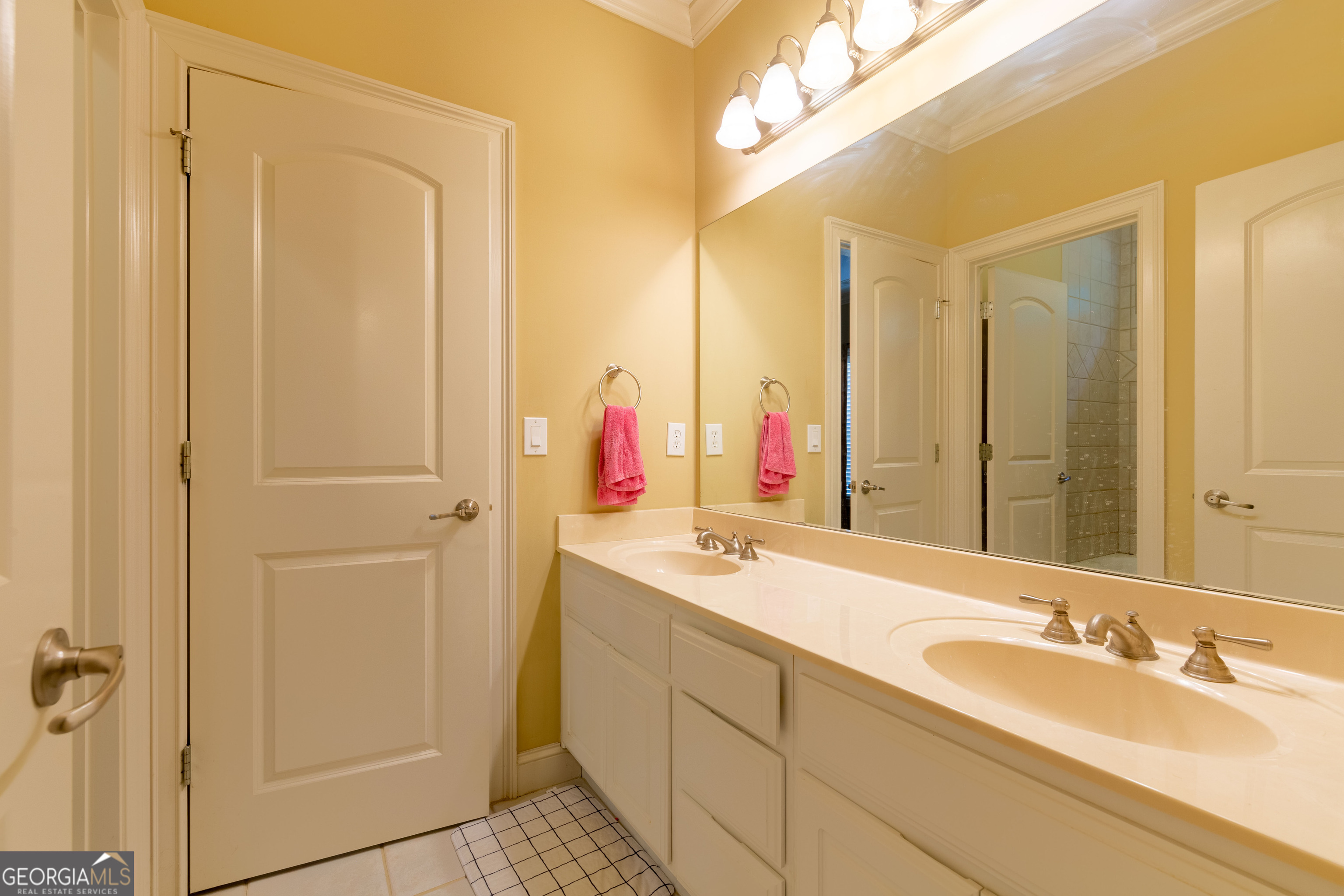 3194 Liverpool Street Jonesboro, GA 30236 - Photo 25 of 44 a bathroom with a double vanity sink and a mirror
