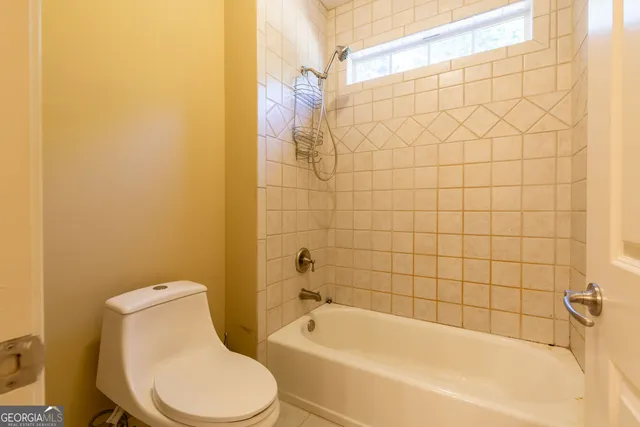 a white bath tub sitting next to a white toilet