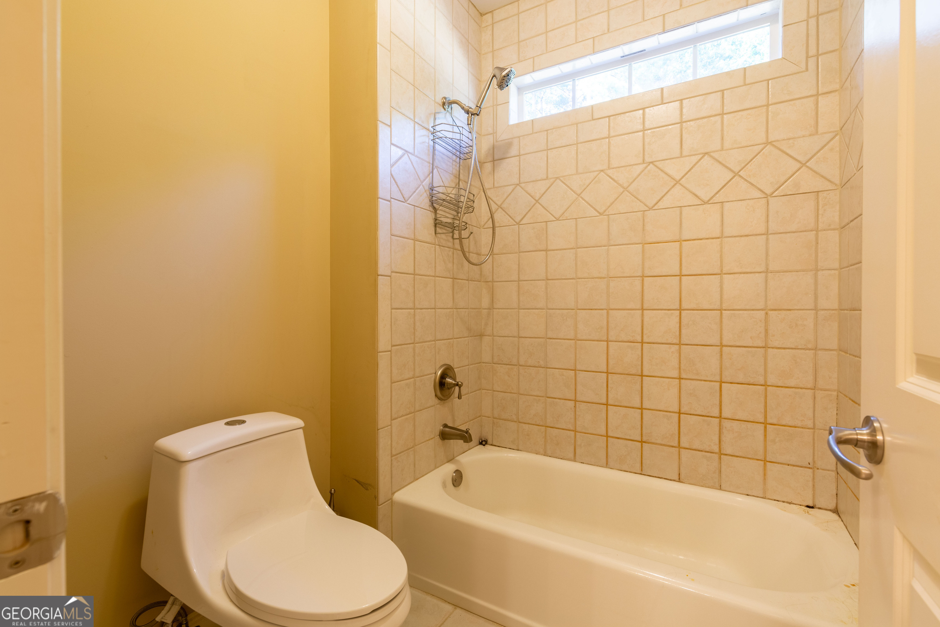 3194 Liverpool Street Jonesboro, GA 30236 - Photo 26 of 44 a white bath tub sitting next to a white toilet