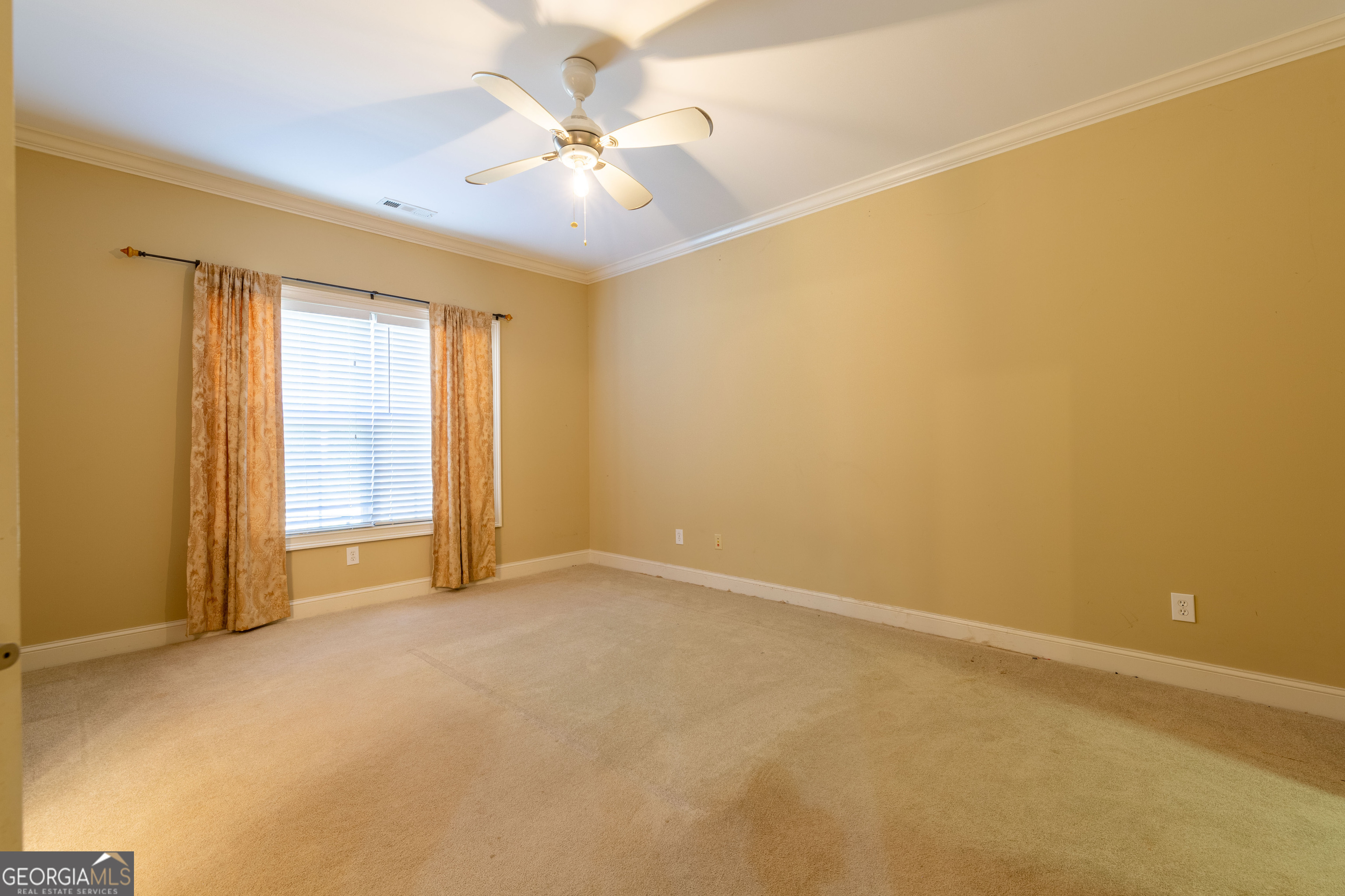 3194 Liverpool Street Jonesboro, GA 30236 - Photo 28 of 44 an empty room with a chandelier fan and windows