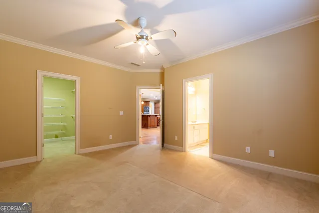 an empty room with fan and entrance