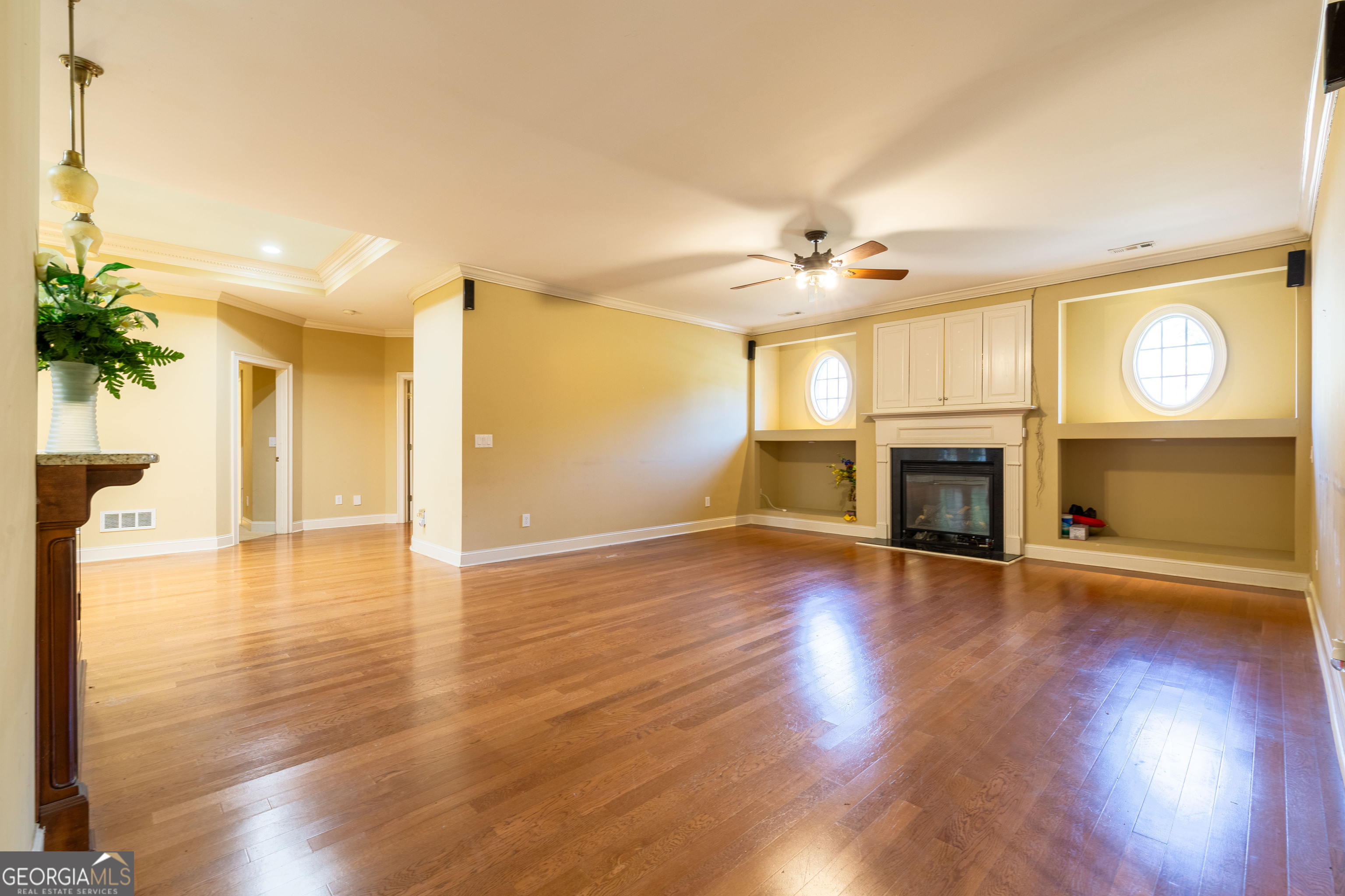 3194 Liverpool Street Jonesboro, GA 30236 - Photo 9 of 44 a view of an empty room with wooden floor and a fireplace