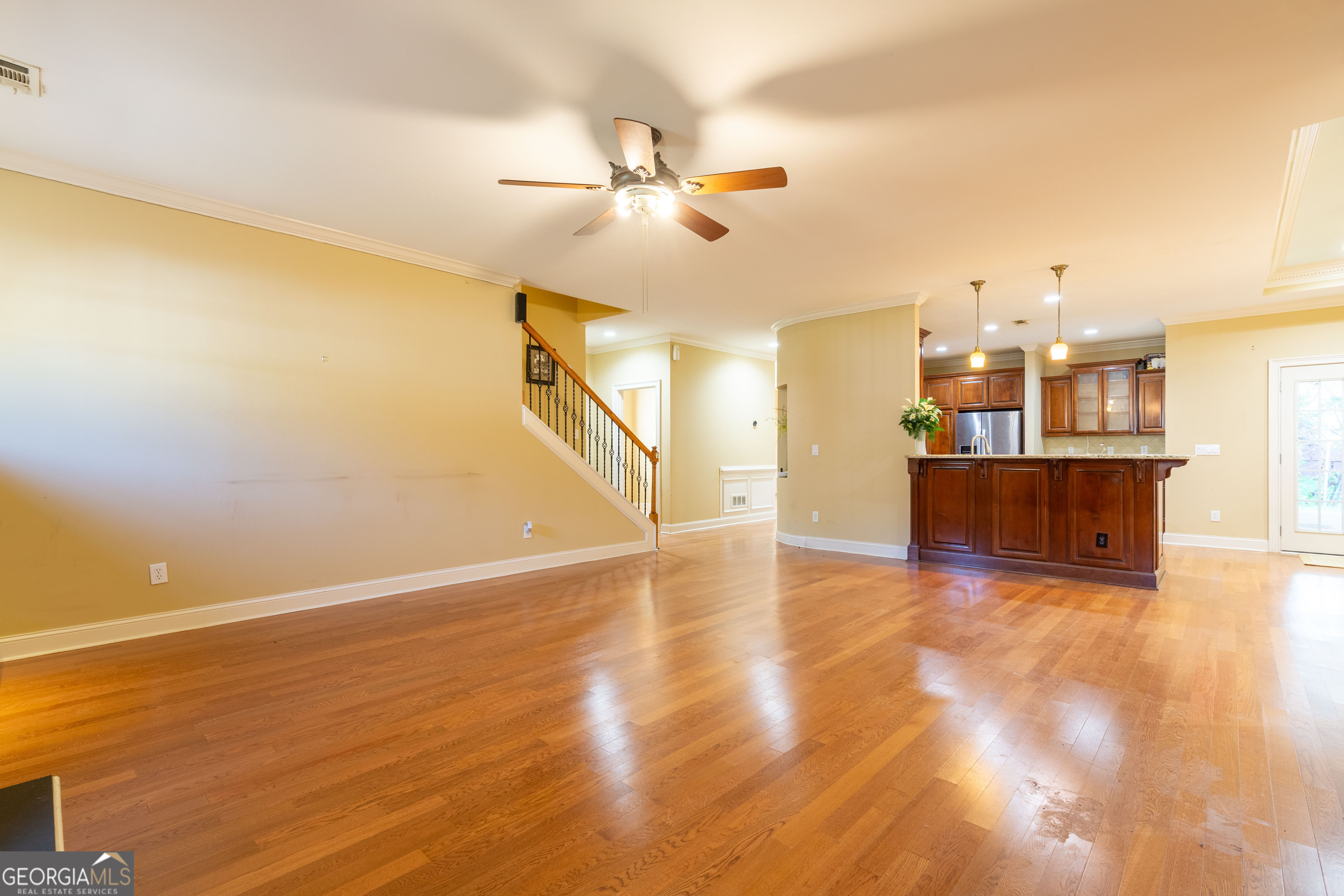 3194 Liverpool Street Jonesboro, GA 30236 - Photo 10 of 44 a view of a kitchen with wooden floor and a ceiling fan