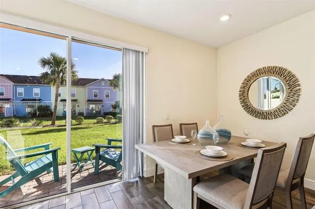 a view of a dining room with furniture and a kitchen